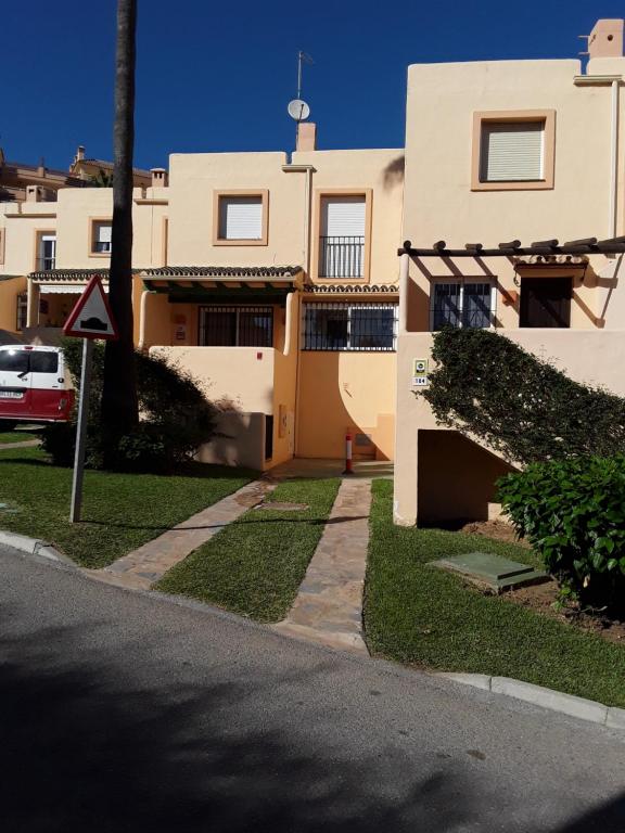 a building on a street with a sign in front of it at Lovely apartment see views,pool and garden,Resort in Fuengirola