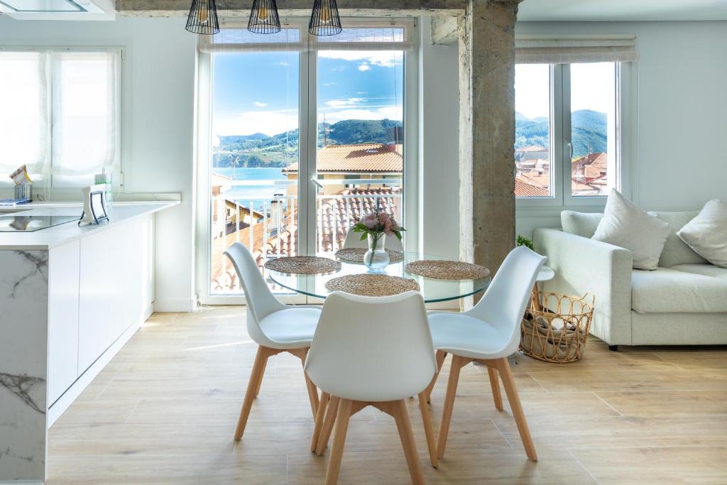 a kitchen and living room with a table and chairs at Mundaka Centre by Urdaibai Rentals in Mundaka
