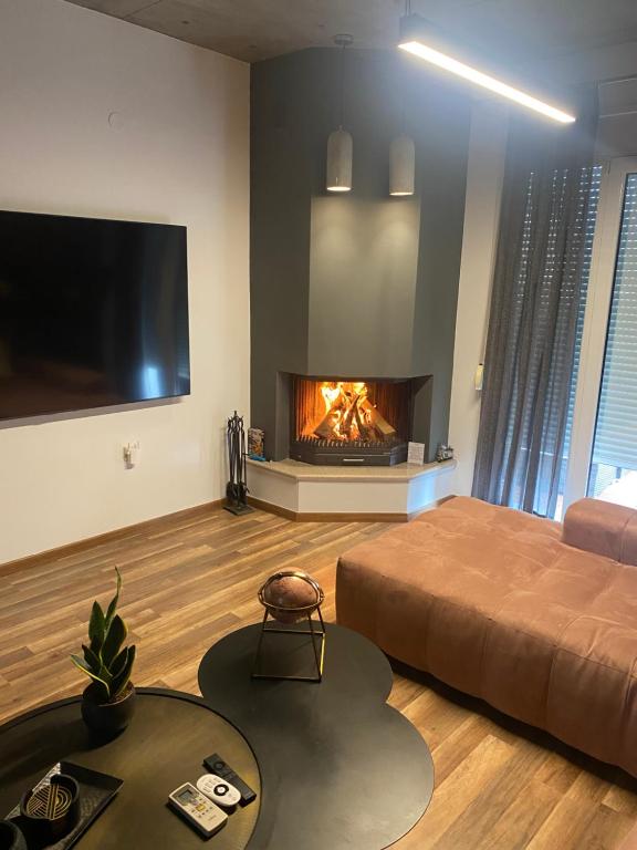 a living room with a bed and a fireplace at The Grey Apartments in Volos