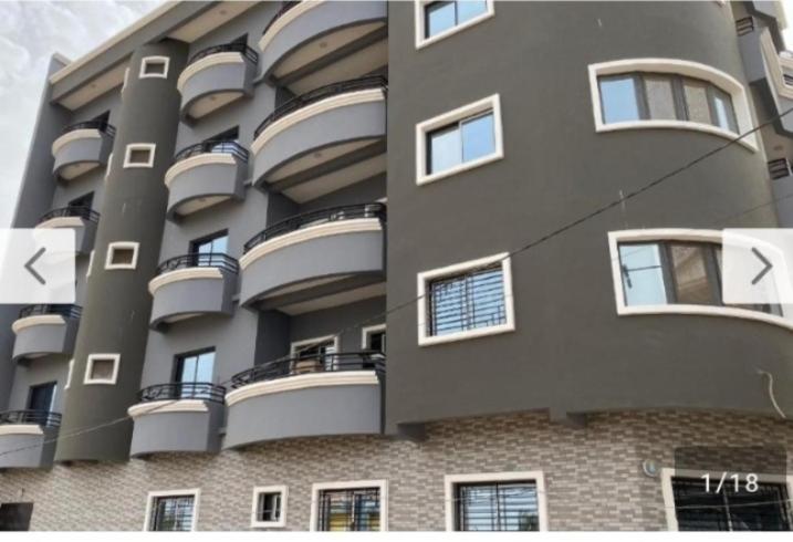 a large building with balconies on the side of it at Résidence La Digue Cité Vauvert in Saint-Louis