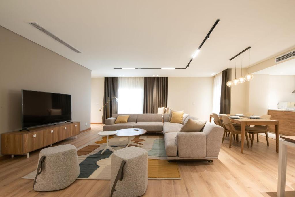 a living room with a couch and a tv at New Cairo, Akoya Residence, Milena in New cairo