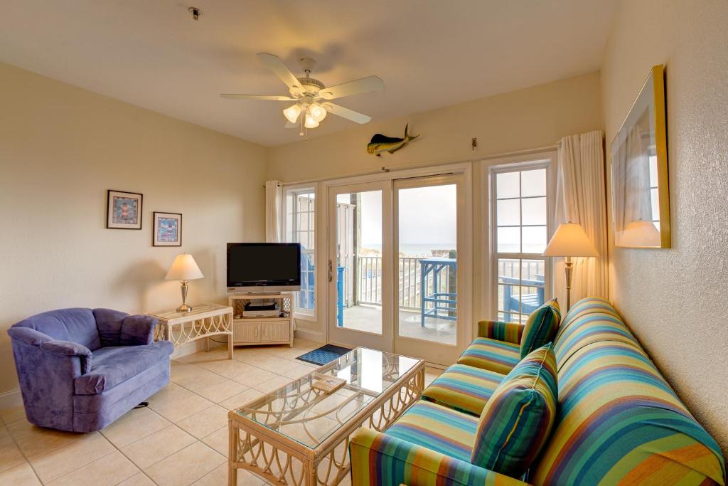 a living room with a couch and a tv at Ocean Breezes 863 #110DS-H in Hatteras