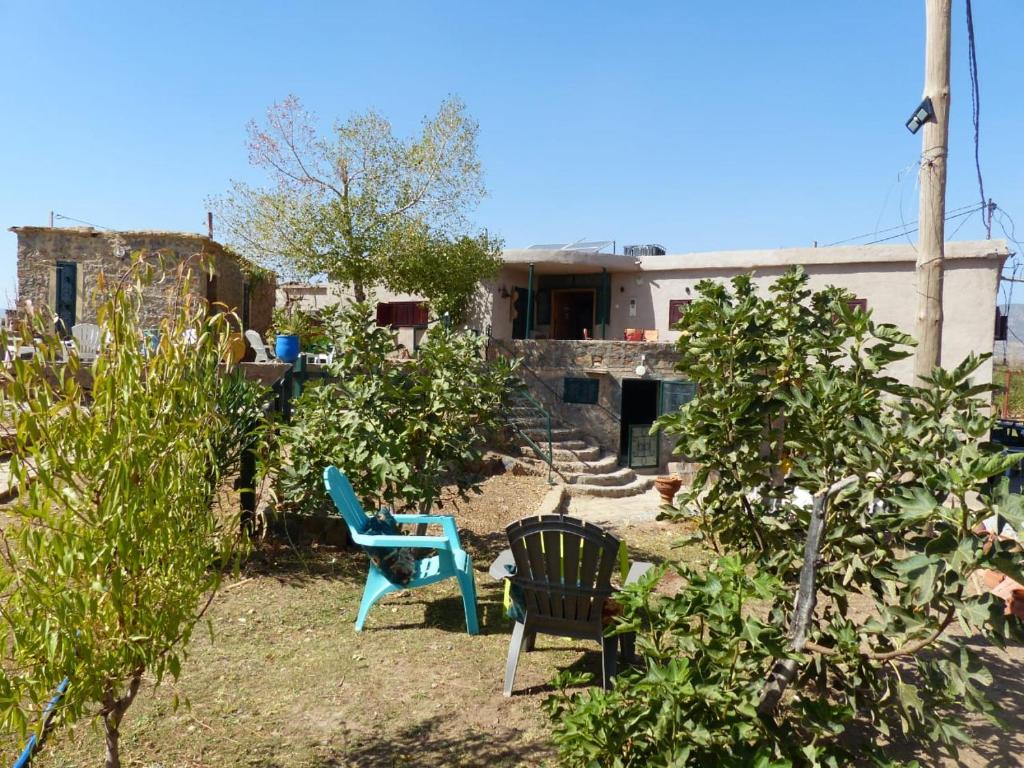 een tuin met twee stoelen en een huis bij Gîte Mourik in Aghbala