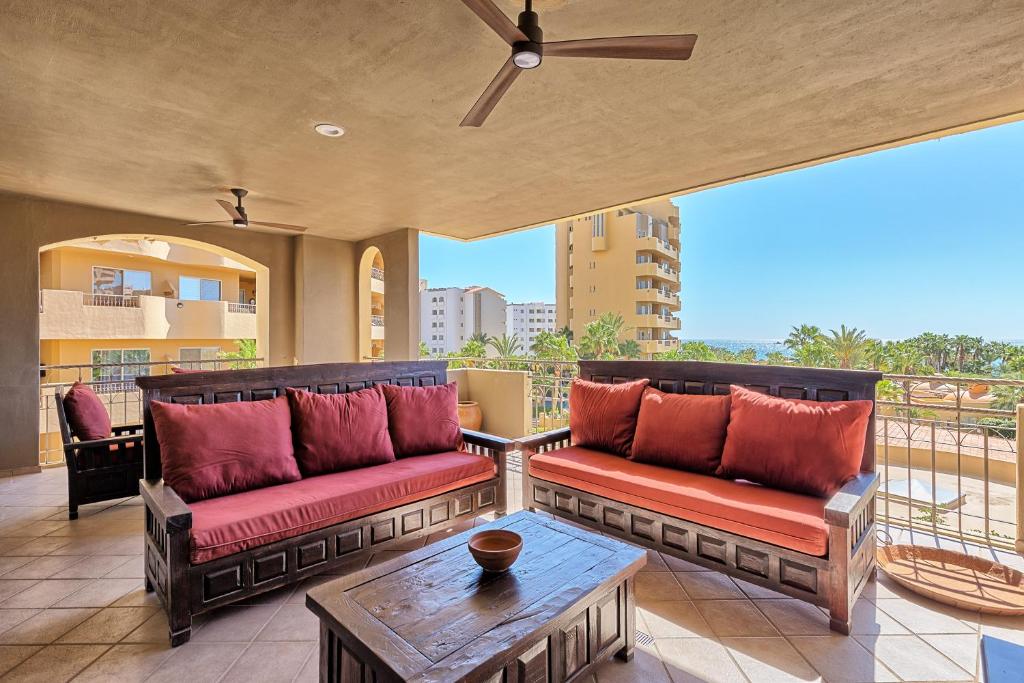 a patio with two couches and a table on a balcony at Bella Sirena 201-C in Puerto Peñasco