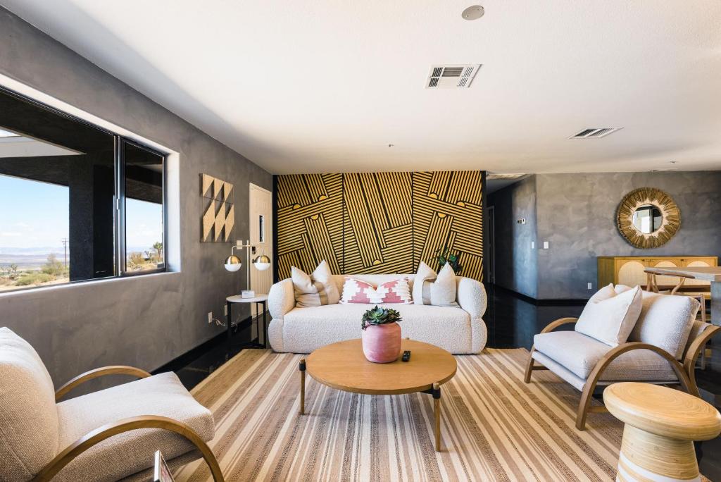 a living room with a couch and a table at @ Marbella Lane - Zen-like Ambiance 3BR Home in JT in Joshua Tree