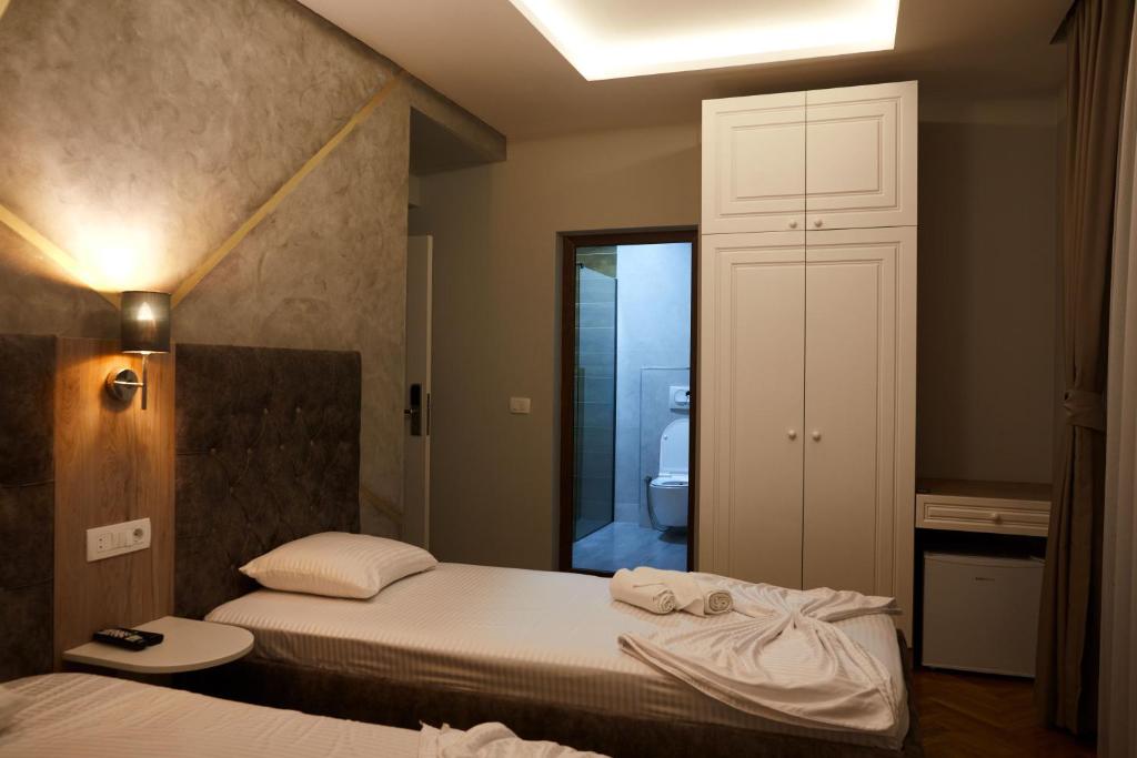 Postel nebo postele na pokoji v ubytování Amico Hotel