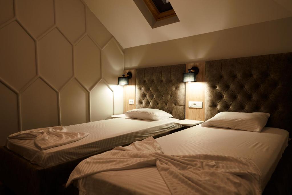 Postel nebo postele na pokoji v ubytování Amico Hotel