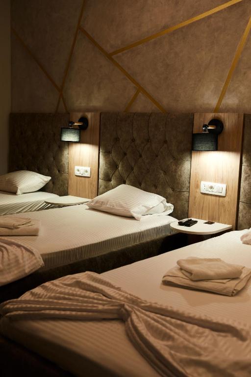 Postel nebo postele na pokoji v ubytování Amico Hotel