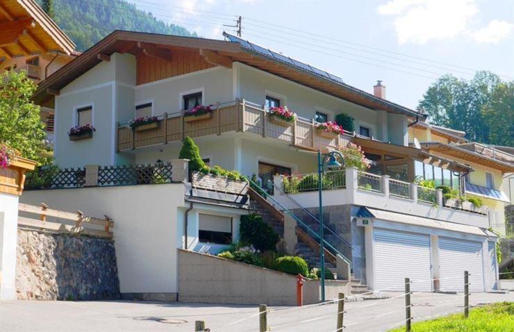 a large white house with balconies on a street at Landler Auszeit in Thiersee