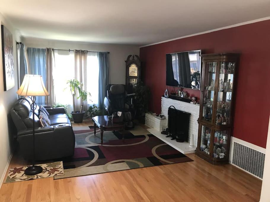 a living room with a couch and a fireplace at 2 bedroom house or Private Studio in quiet neighborhood near SF, SFSU and SFO in Daly City