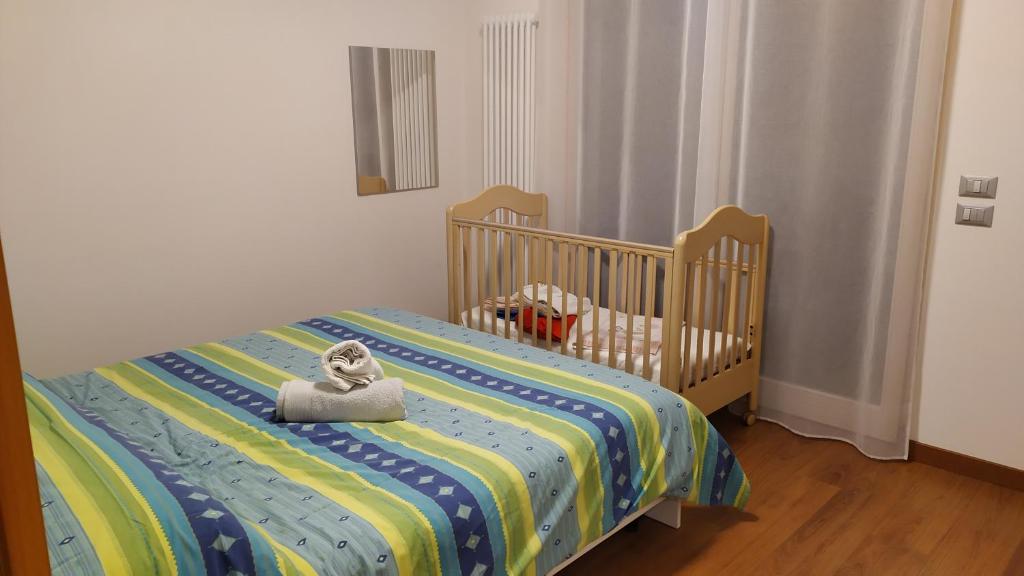 - un lit bébé avec un animal rembourré assis dans l'établissement Casa Mirella (cipat 022236-AT-849841), à Vigolo Vattaro