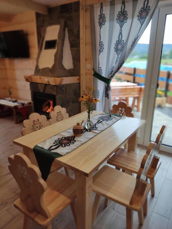 a table and chairs with a fireplace in a room at Mały Zakątek Dzianisz "Balia na wyłączność" in Dzianisz