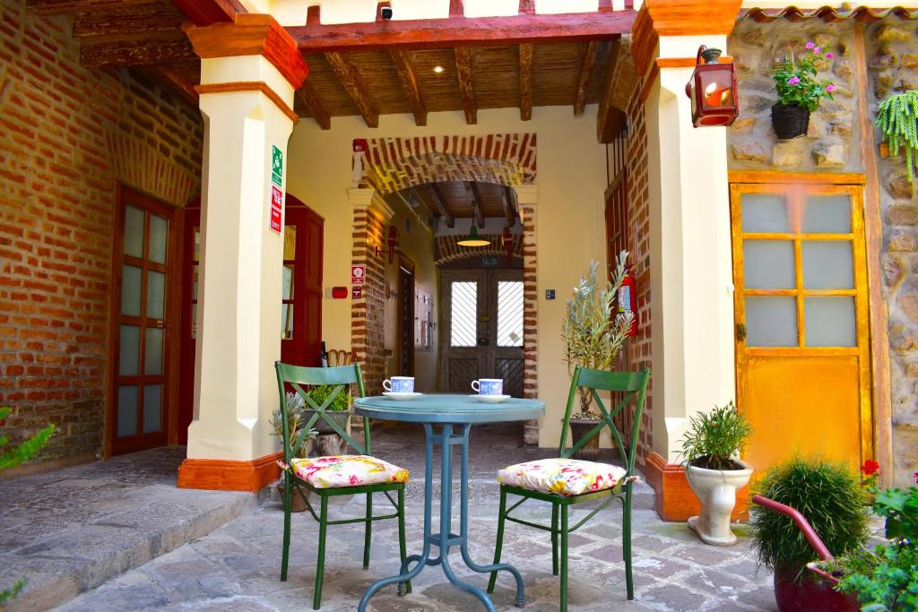 a blue table and chairs on a patio at Old Town Quito Suites, Heritage Boutique Hotel, Where Every Detail Tells a Story in Quito