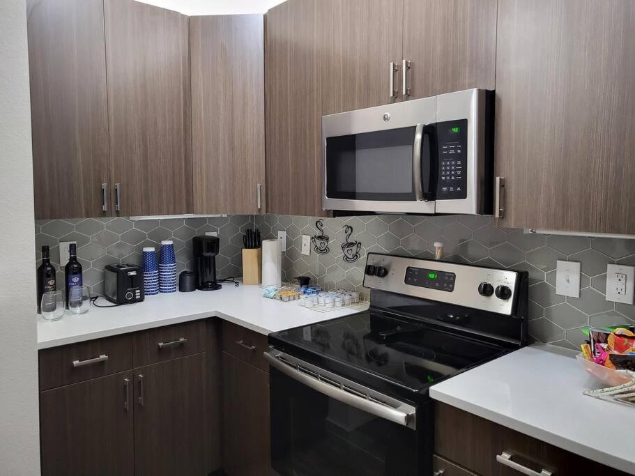 a kitchen with a microwave and a stove top oven at Beautiful one bedroom with courtyard access in Raleigh