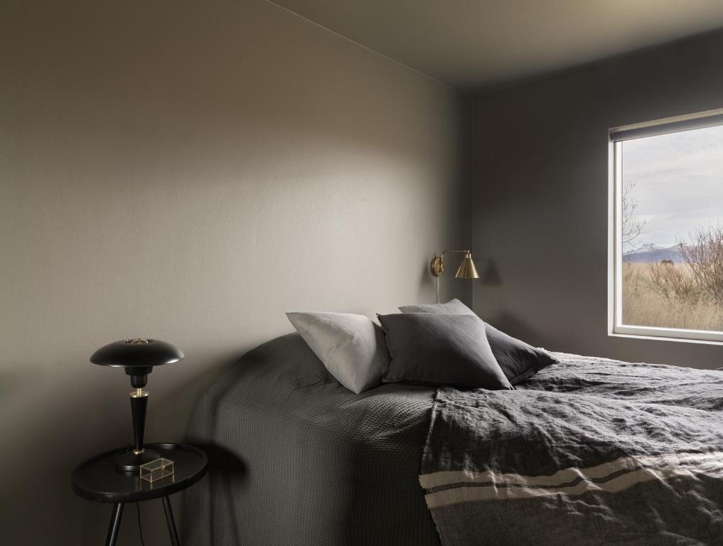 a bedroom with a bed and a window at Klöpp Lodge - Snæfellsnes Peninsula in Stykkishólmur