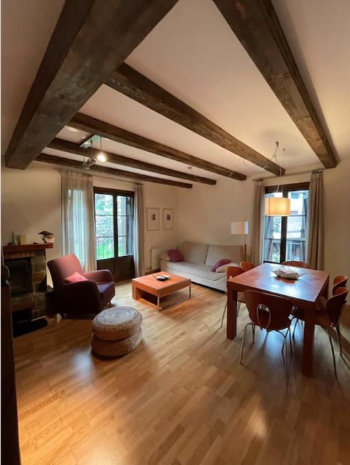 a living room with a couch and a table at CHECK-IN CASAS Casa Plaza Mayor in Villanova