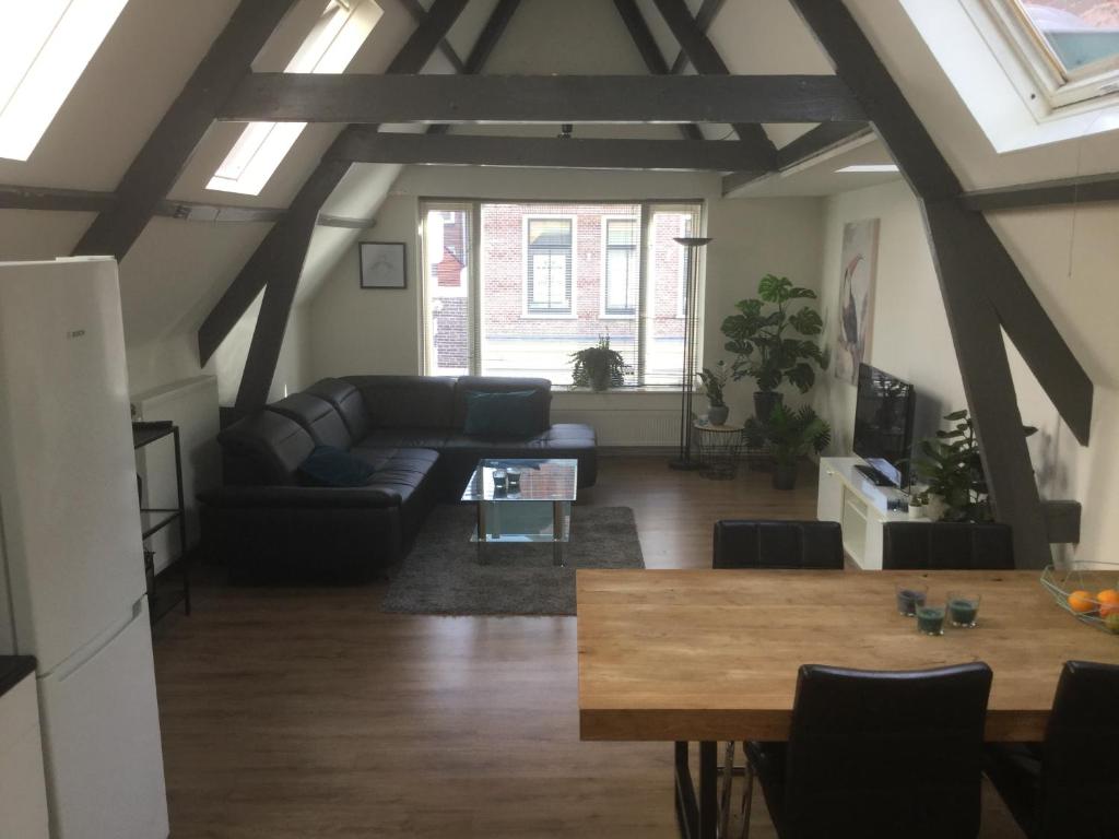 a living room with a couch and a table at Appartementen Purmerend A in Purmerend