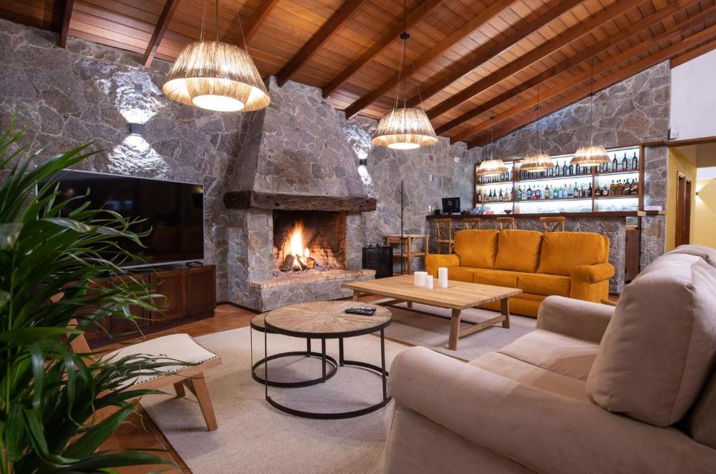 a living room with a couch and a fireplace at Bemar Carmelo Hotel in Carmelo