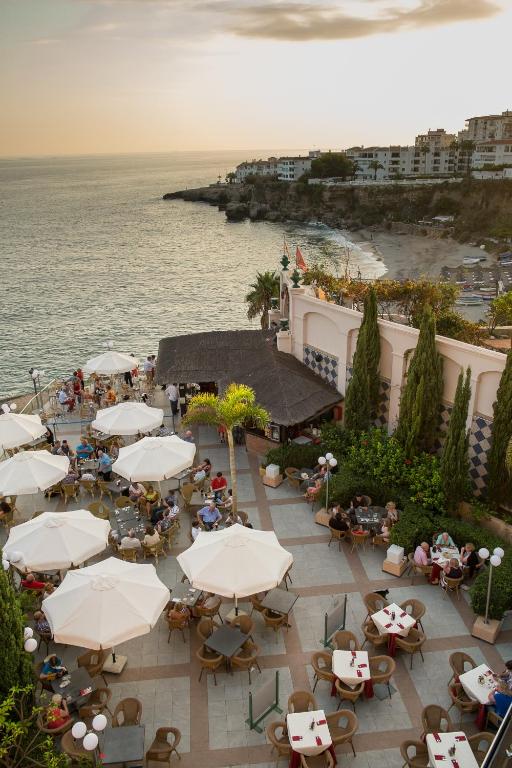 an overhead view of a patio with umbrellas and the ocean at Toboso Apar - Turis in Nerja