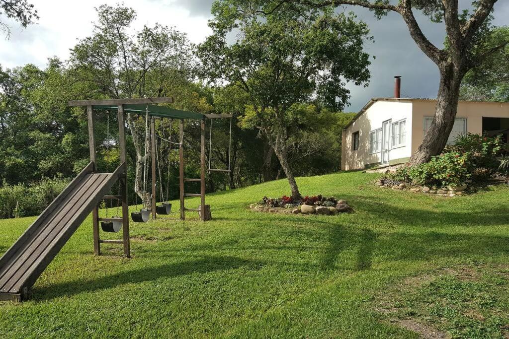 un parque infantil con un tobogán en un patio en Los Petti casa de campo en Salta
