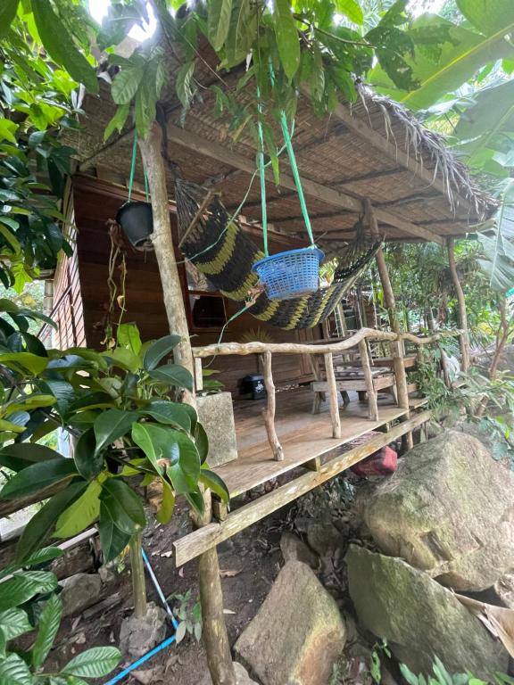 a tree house with a hammock in a forest at Happy Hippy House2 in Ko Chang