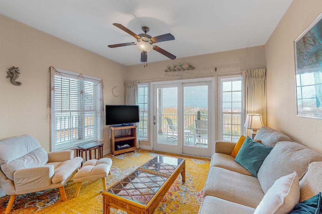 a living room with two couches and a tv at Hatteras Hospitality 806 #101DS-H in Hatteras