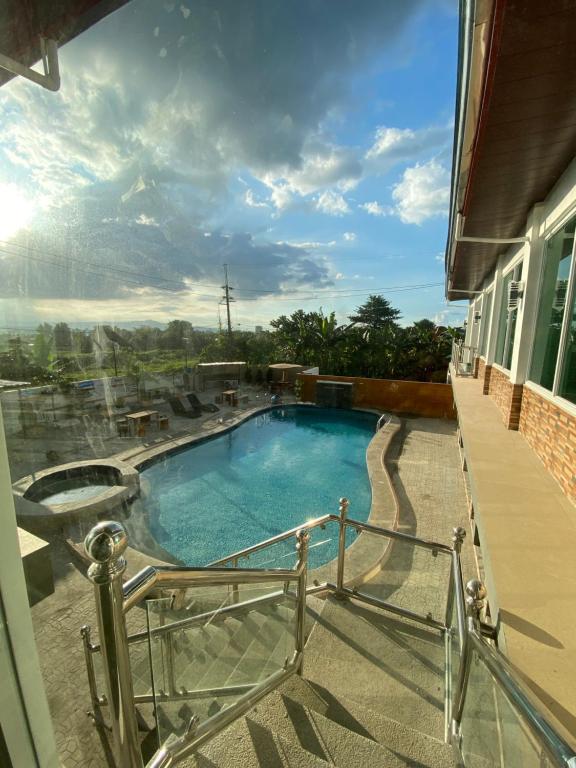 a swimming pool on the balcony of a house at RedDoorz @ Piamonte Apartelle Santo Tomas Batangas in Santo Tomas