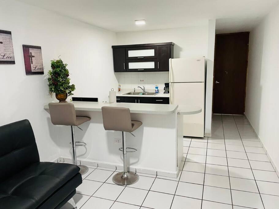 a kitchen with a counter and a sink and a refrigerator at Costa Relax 2 in Guayama