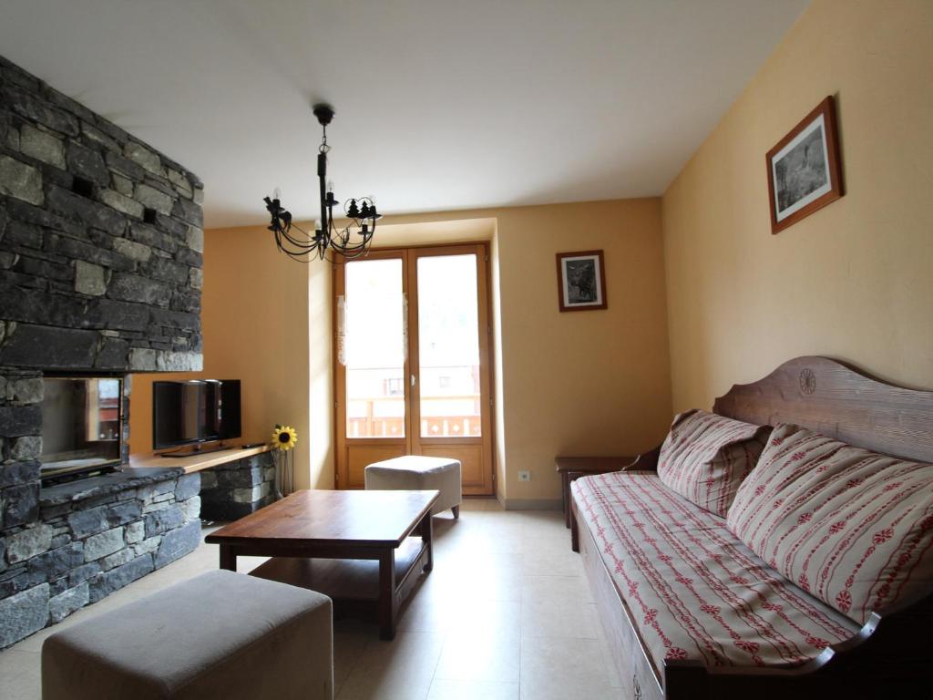 a living room with a couch and a fireplace at Appartement Lanslebourg-Mont-Cenis, 4 pièces, 10 personnes - FR-1-508-43 in Lanslebourg-Mont-Cenis