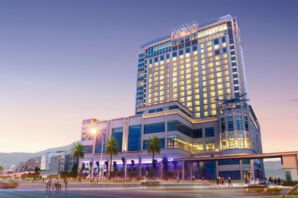 a rendering of a building with palm trees in front of it at The Light Hotel Penang in Perai
