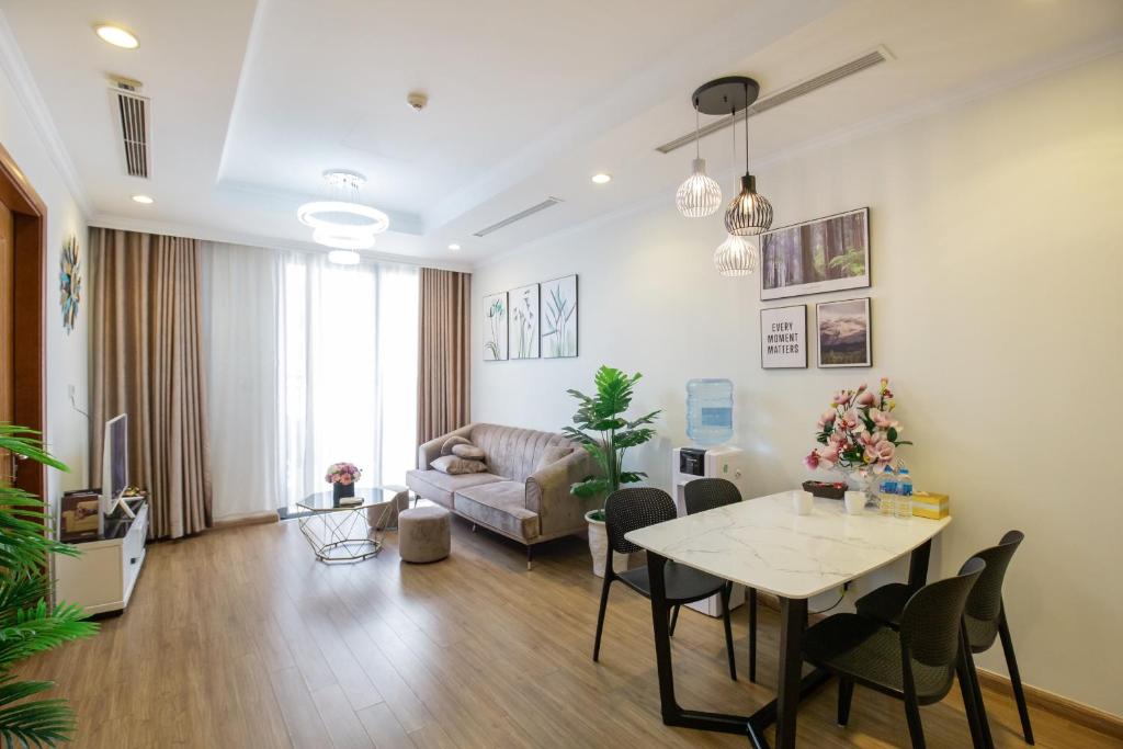a living room with a table and a couch at Times City Homestay in Hanoi
