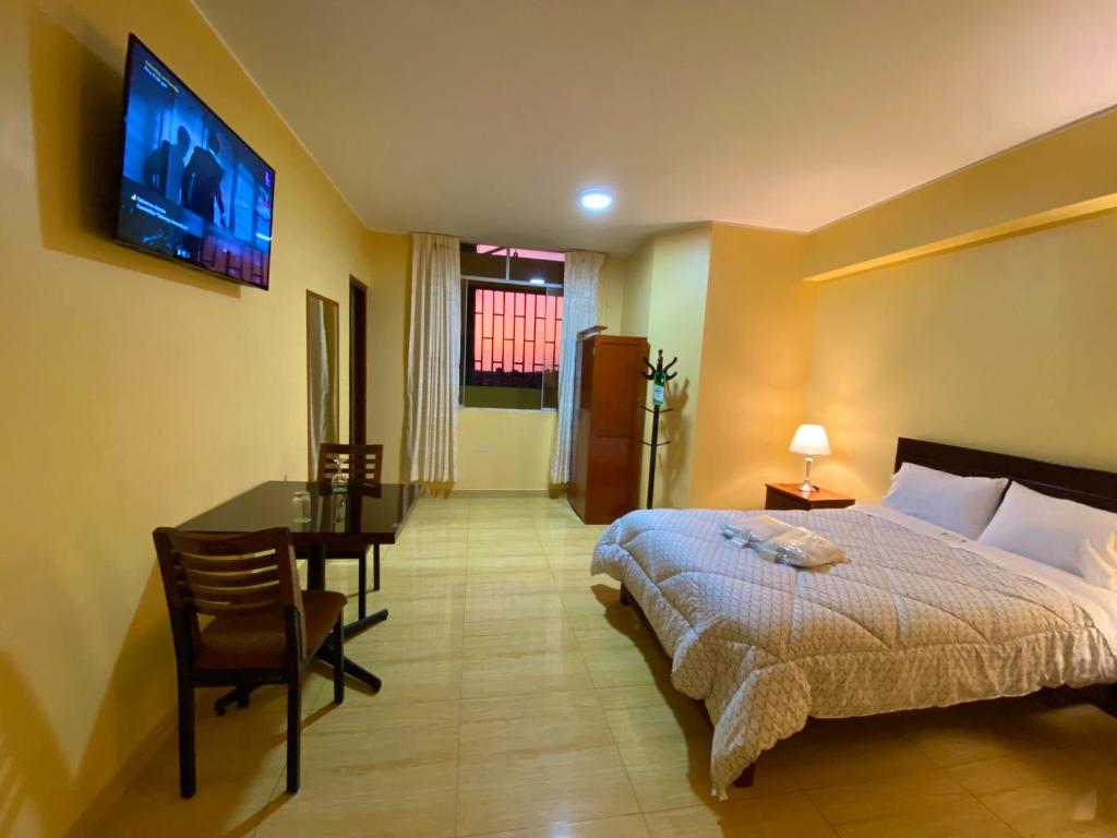 Postel nebo postele na pokoji v ubytování Hotel Las Palmeras