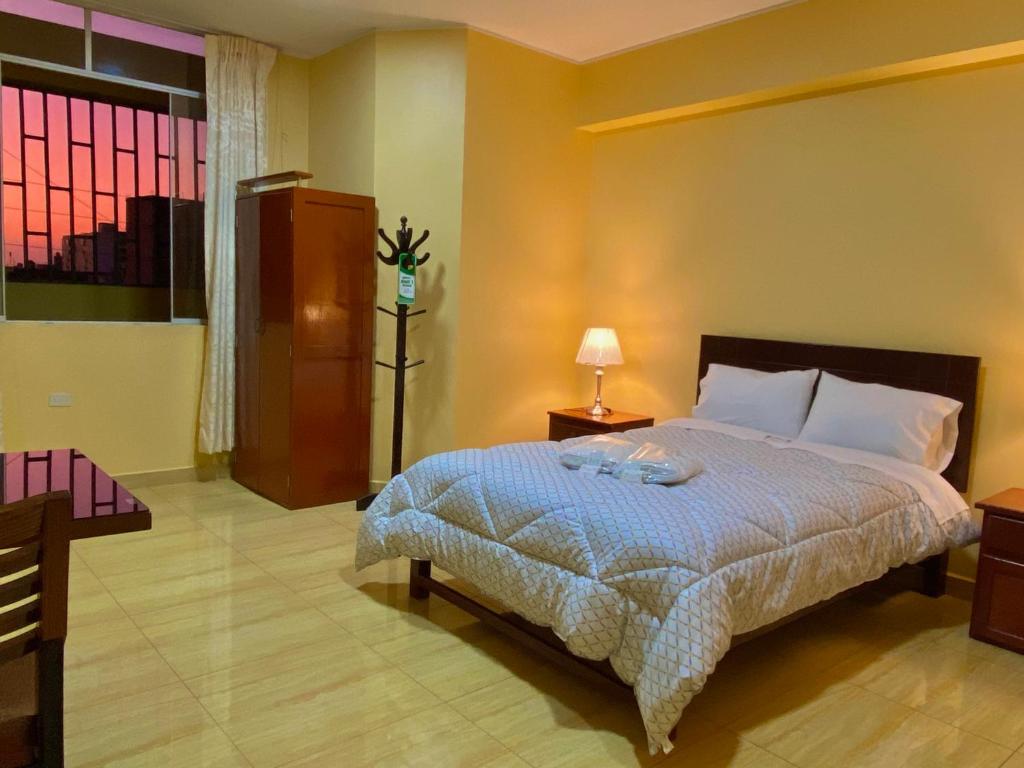 Postel nebo postele na pokoji v ubytování Hotel Las Palmeras