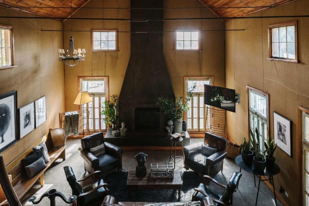 a living room filled with furniture and a fireplace at The Barn Daylesford in Daylesford