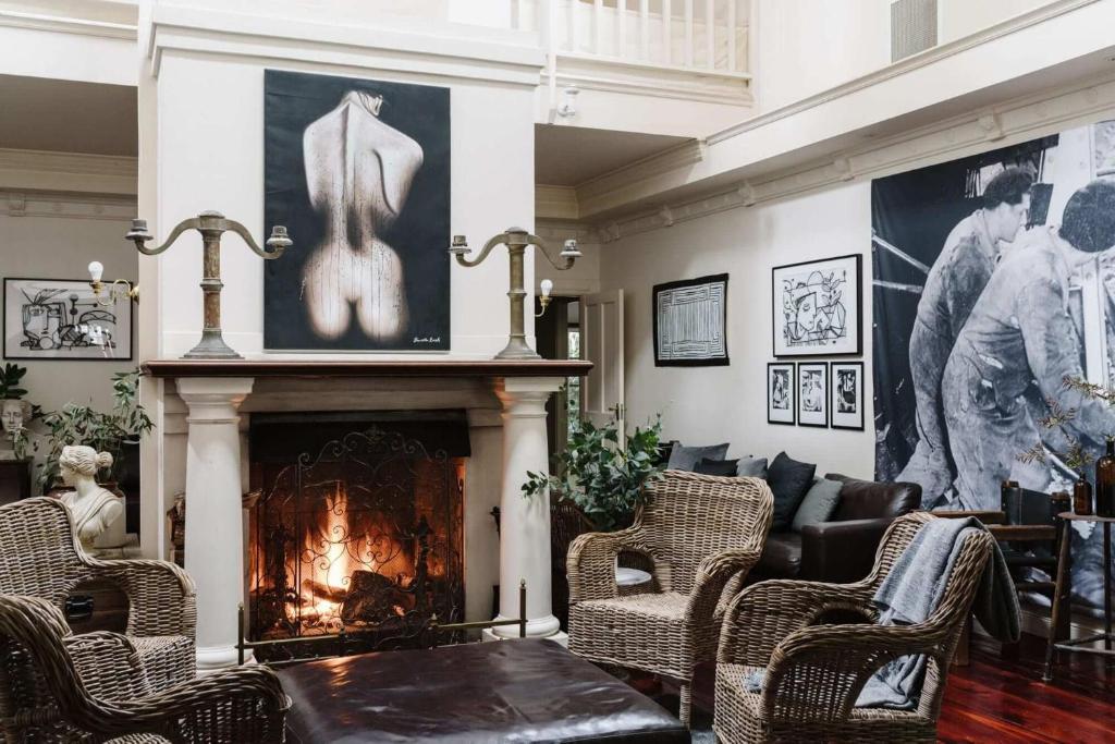 a living room with a fireplace and a fire place at The Manor House Daylesford in Daylesford
