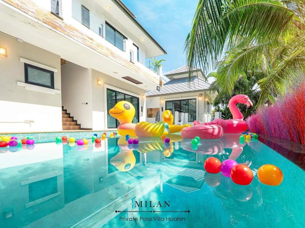 a pool with inflatable rubber ducks in the water at Milan Private Pool Villa Huahin in Hua Hin