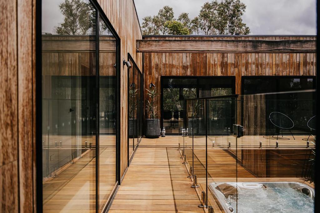 an external view of a house with glass doors at The Deck - Hepburn Springs Daylesford in Hepburn