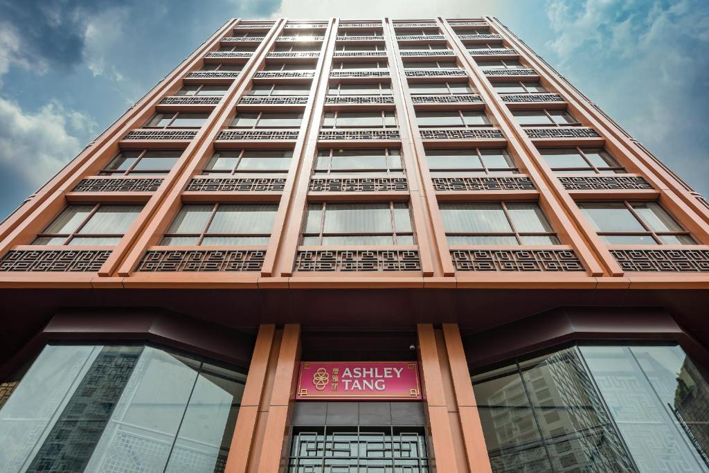 a tall building with a pink sign on it at Ashley Tang Menteng Jakarta in Jakarta