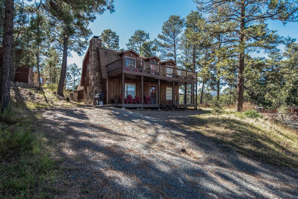 a large house on a hill with trees at Stay Happy in Ruidoso