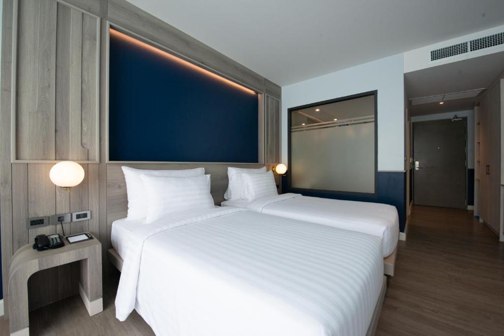 Postel nebo postele na pokoji v ubytování Seabed Grand Hotel Phuket - SHA Extra Plus