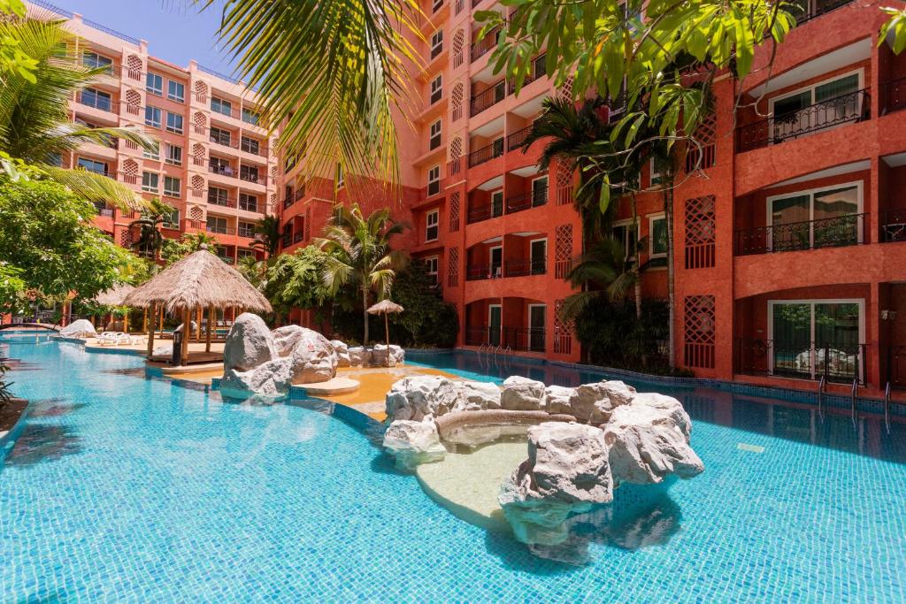 a swimming pool with rocks in a resort at SEVEN SEAS CONDO RESORT in Jomtien Beach