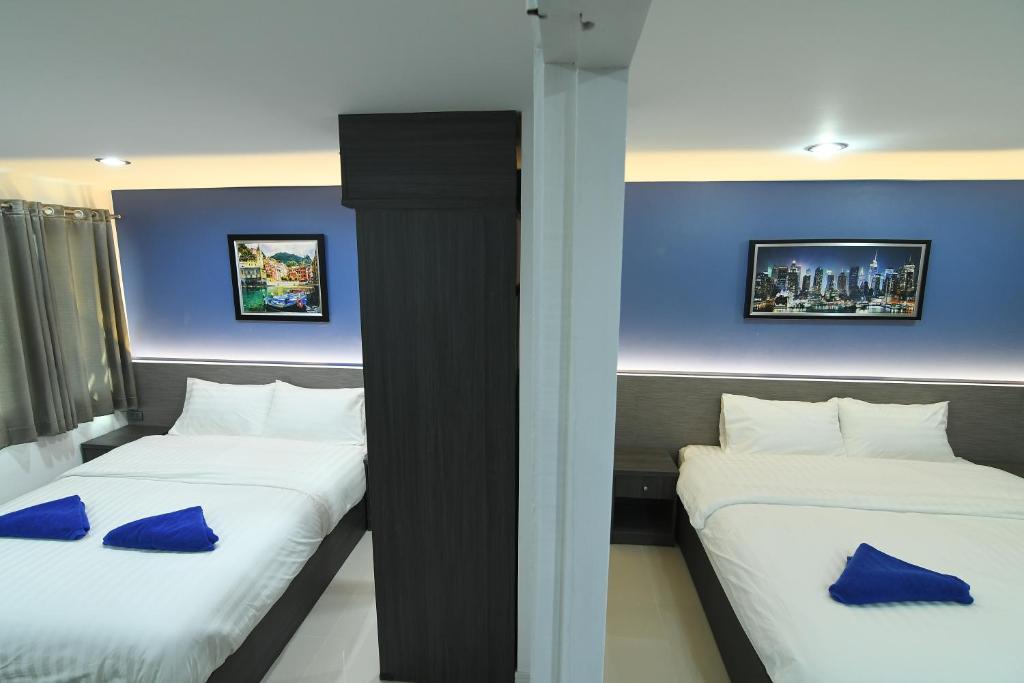 Postel nebo postele na pokoji v ubytování Poonsuk Place Hotel