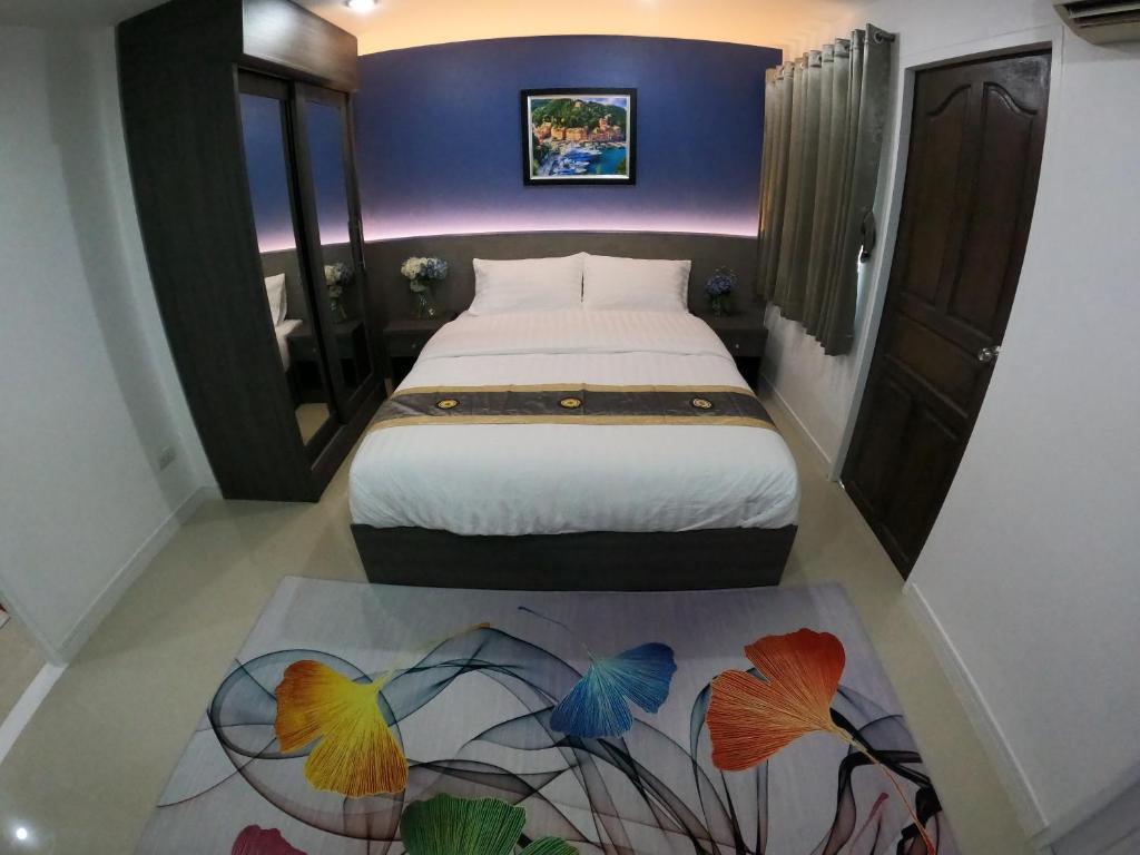 Postel nebo postele na pokoji v ubytování Poonsuk Place Hotel