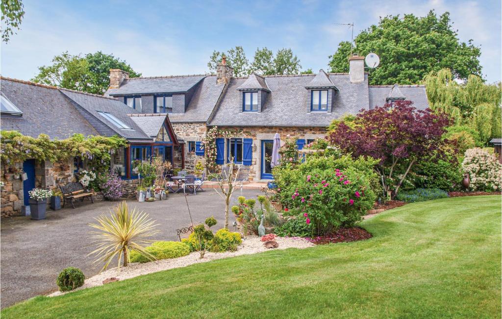 an exterior view of a house with a garden at Awesome Home In Trézélanbégard in Trézelan