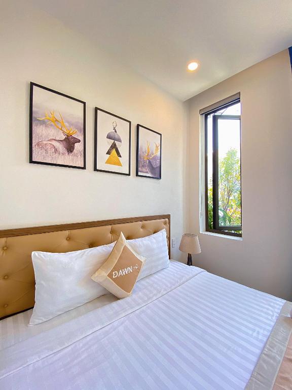 Postel nebo postele na pokoji v ubytování Dawn Villa Homestay Hội An