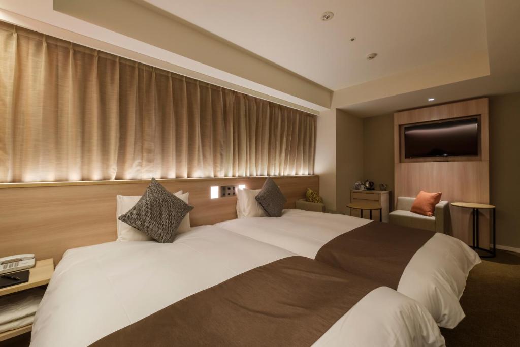 Postel nebo postele na pokoji v ubytování Hotel JAL City Haneda Tokyo West Wing