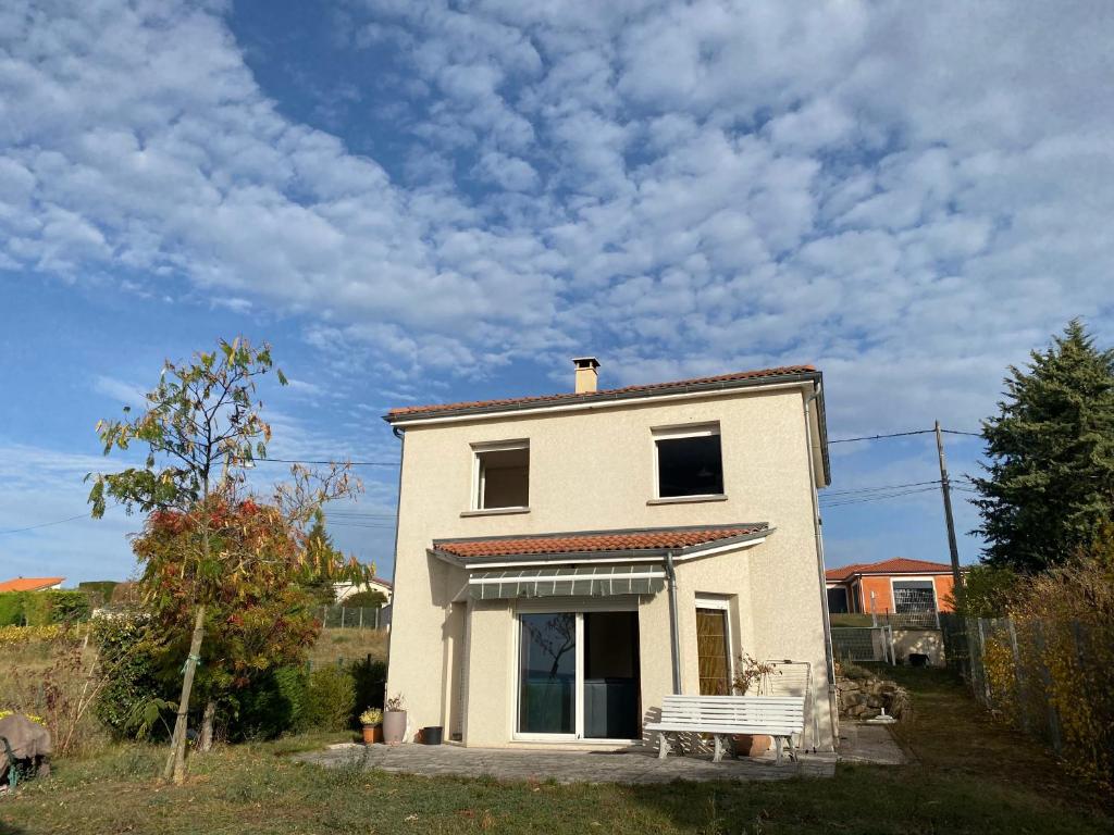 a small white house with a sky at Maison PHILIPPE et Fils in Saint-Bonnet-près-Riom