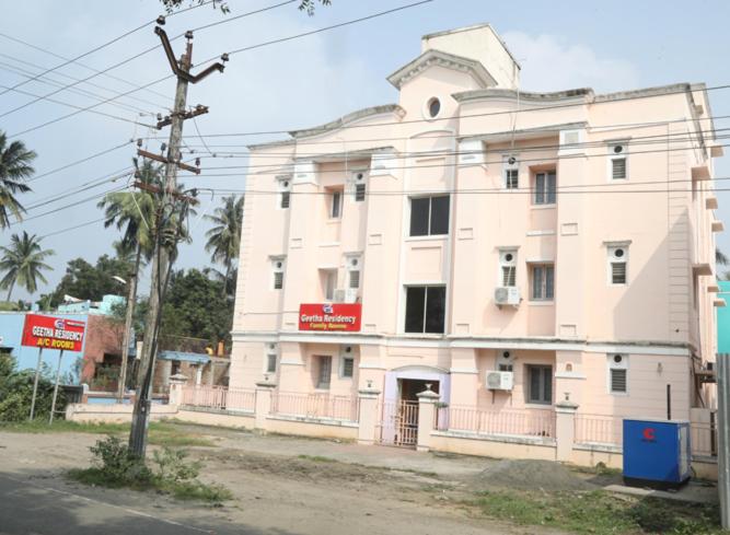 a large white building on the side of a street at Geetha Residency in Kanchipuram