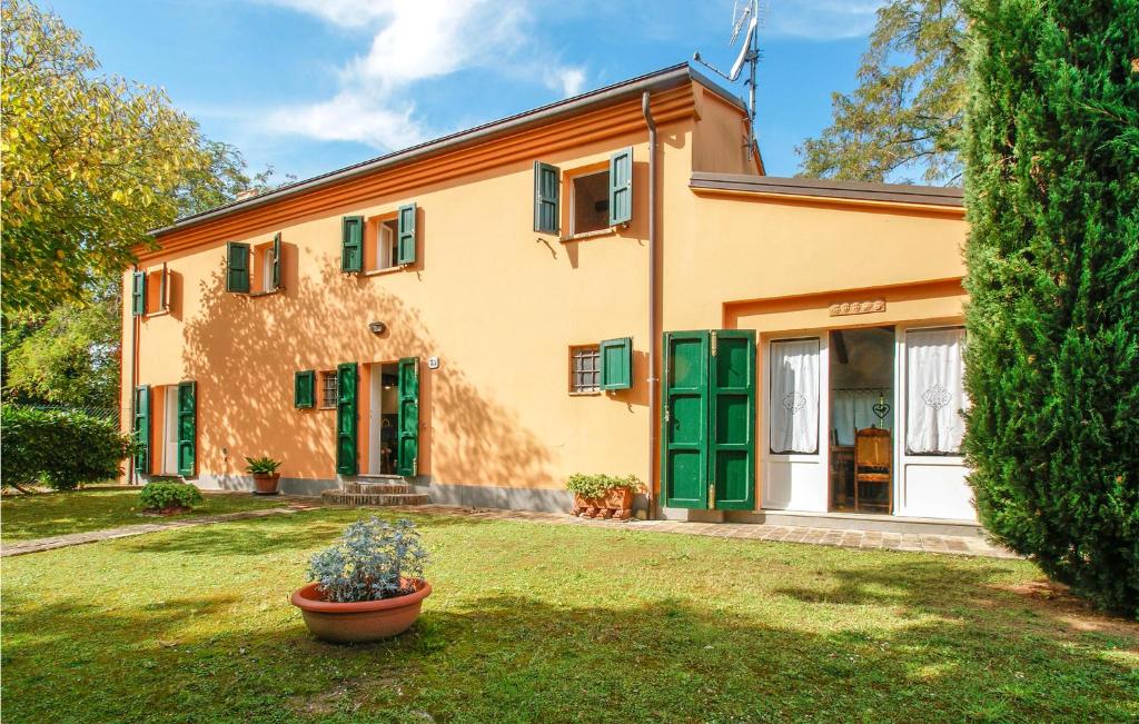 a house with green doors and a yard at Cozy Home In Trebbiantico Di Pesaro With House A Panoramic View in Trebbiantico