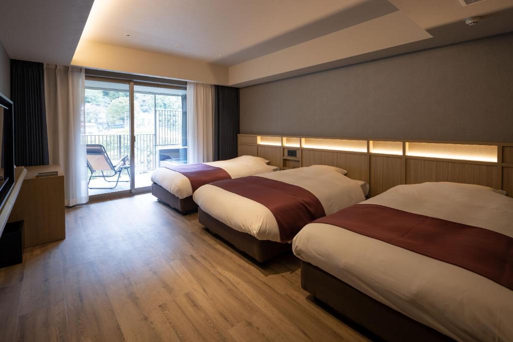 Postel nebo postele na pokoji v ubytování Minakami Onsen Aratashi Minakami